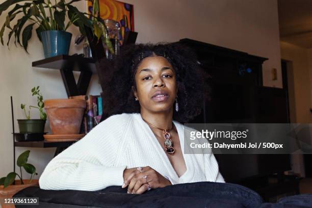 Portrait of African-American woman looking at camera at home