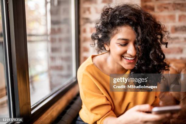 using mobile phone. - modern india stock pictures, royalty-free photos & images