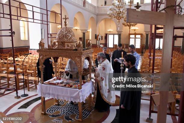 Greek Orthodox priests perform Holy Friday ceremony mass in empty church, transmitted live on the web on April 17, 2020 in Athens, Greece. As part of...