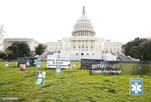 In a protest designed to adhere to social-distancing and with care taken for safety 000 pop-up signs were arranged on the lawn of the U.S. Capitol...