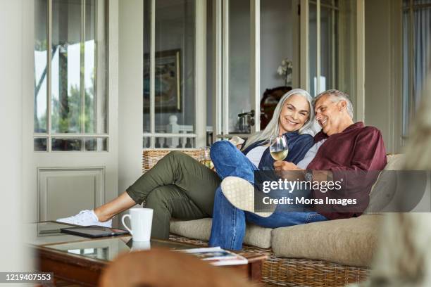 happy couple enjoying wine at home - wine enjoyment stock pictures, royalty-free photos & images