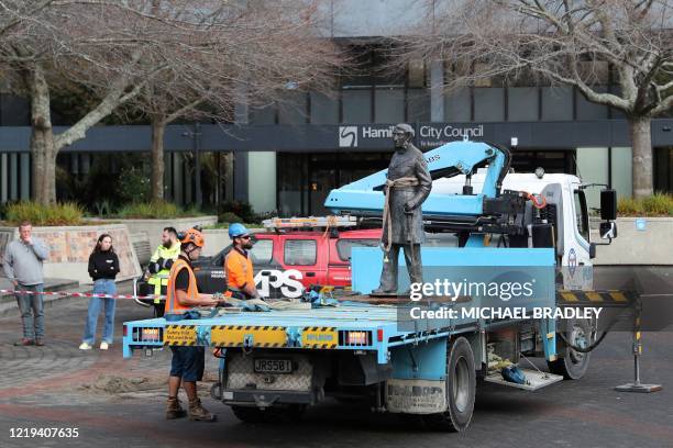 Workers remove a controversial statue of Captain John Fane Charles Hamilton from Civic Square in Hamilton on June 12 following a formal request by...