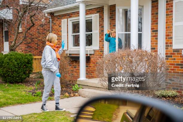 neighbors helping each other. - social distancing friends stock pictures, royalty-free photos & images