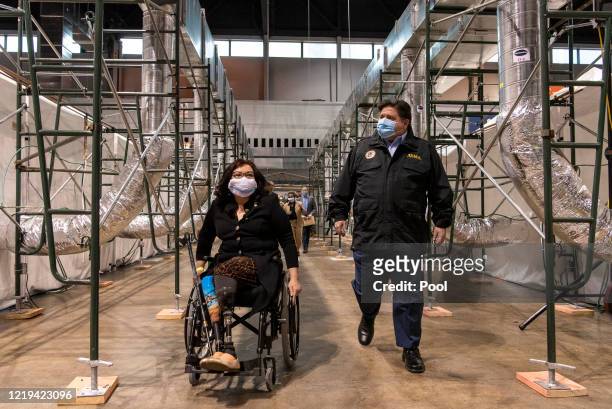 Sen. Tammy Duckworth and Illinois Gov. J.B. Pritzker tour the COVID-19 alternate care facility constructed at the McCormick Place convention center...