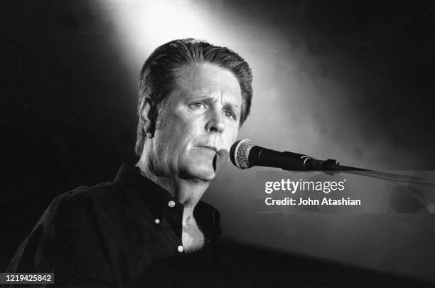 Musician Brian Wilson, best known as the leader and chief songwriter of the Beach Boys, is shown performing on stage during a "live" concert...