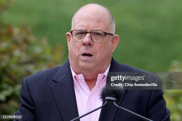 Maryland Governor Larry Hogan talks to reporters during a news briefing about the ongoing novel coronavirus pandemic in front of the Maryland State...