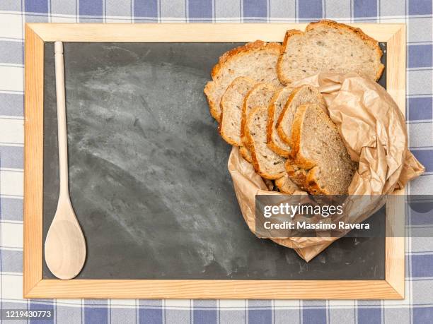 empty blackboard with slices of bread and a wooden spoon. - brown paper towel stock pictures, royalty-free photos & images