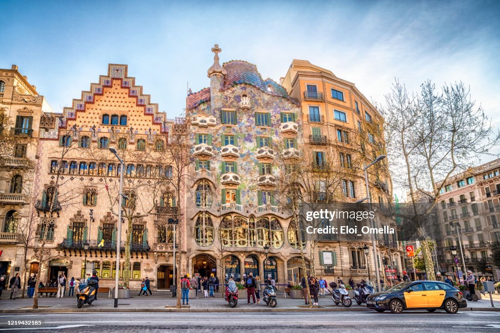 Taxi in front of Casa Batllo and Casa Amatller in Passeig de Gracia in Barcelona at sunset