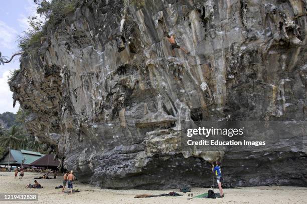 Young rock climbers on Hat Ton Sai cliff Railway Beach Thailand.
