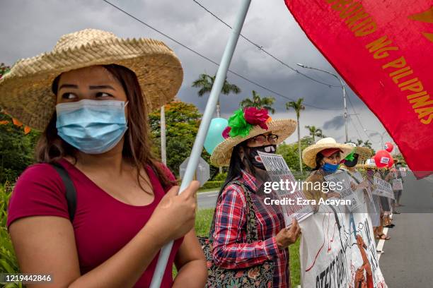 Filipinos wearing face masks take part in a protest against President Duterte's Anti-Terror bill on June 12, 2020 in Quezon city, Metro Manila,...