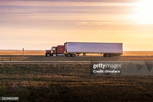 semi truck on the  rural trans-canada highway - saskatchewan highway stock pictures, royalty-free photos & images