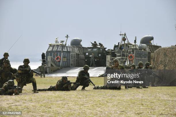 Japanese Ground Self-Defense Force and U.S. Marines conduct a joint exercise on Feb. 9 at the Blue Beach training area in Kin in Okinawa Prefecture,...