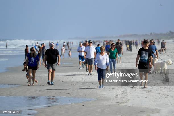 People are seen at the beach on April 17, 2020 in Jacksonville Beach, Florida. Jacksonville Mayor Lenny Curry announced Thursday that Duval County's...