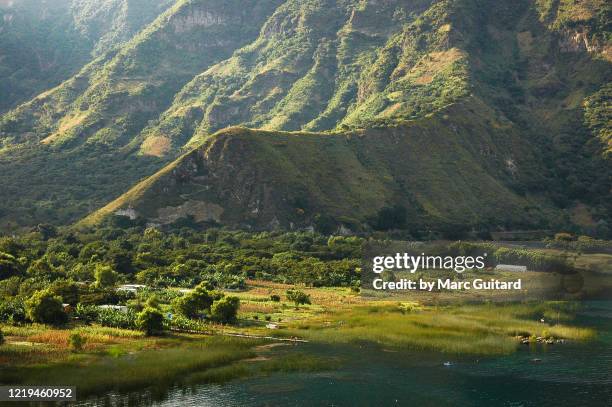 beautiful landscape along the shores of lake atitlan, guatemala - guatemala landscape stock pictures, royalty-free photos & images