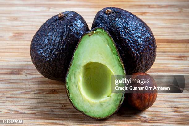 sliced avocado on wood - gunnar örn árnason stock pictures, royalty-free photos & images