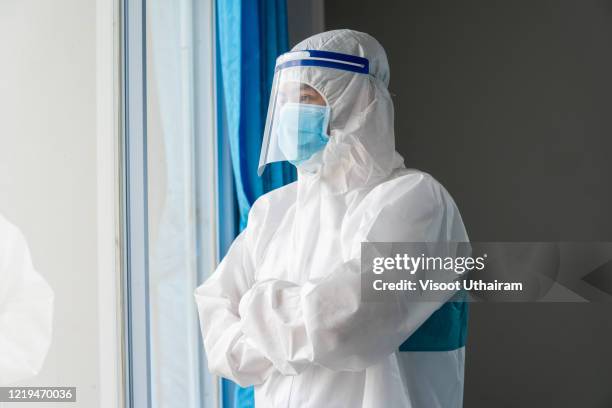 doctor wearing protective suit to fight coronavirus pandemic covid-2019. - thailand covid stock pictures, royalty-free photos & images