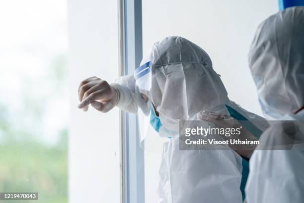 doctor wearing protective suit to fight coronavirus pandemic covid-2019. - covid 19 stock pictures, royalty-free photos & images