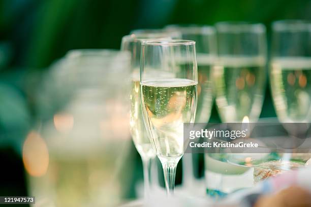 glass of champagne on the green background - champagne popping stock pictures, royalty-free photos & images