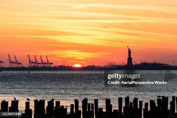 statue of liberty at sunset / nyc harbor, manhattan - new york harbour stock pictures, royalty-free photos & images