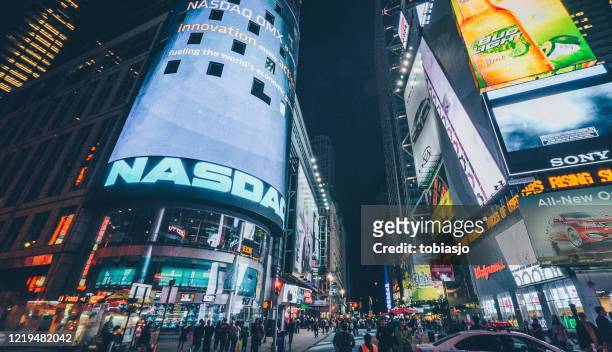 nasdaq stock exchange billboard at times square in new york city - nasdaq stock pictures, royalty-free photos & images