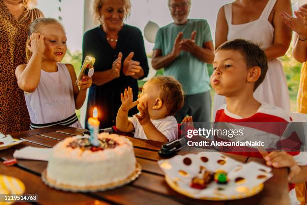 happy family celebrating baby's first birthday - 1st birthday stock pictures, royalty-free photos & images