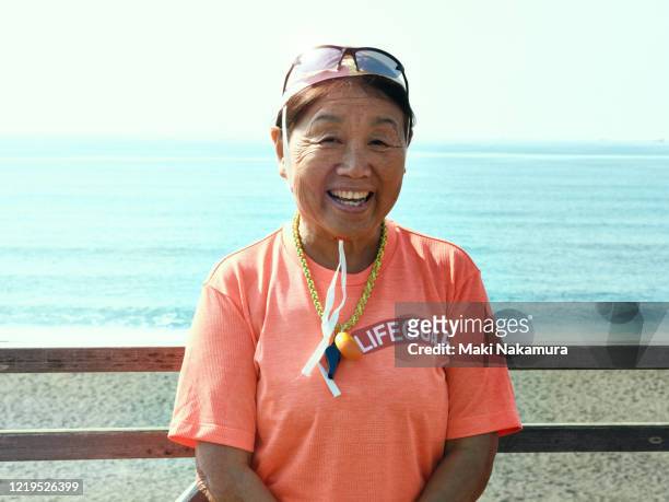 69 year old female lifesaver portrait - 65 year old asian women stockfoto's en -beelden