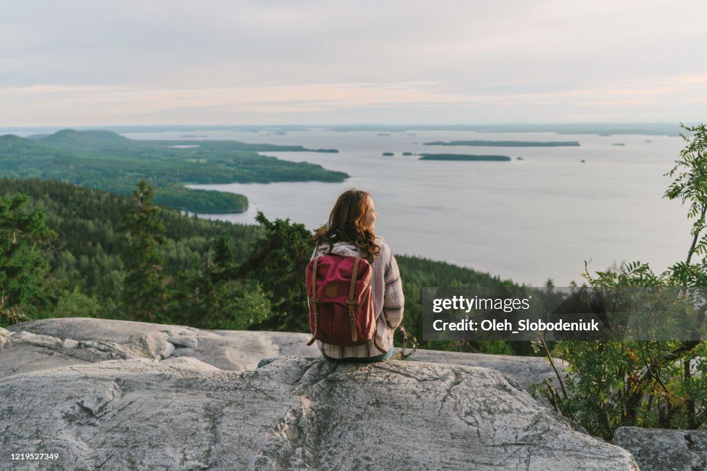 Scenic  view of woman looking at  lake in Finland