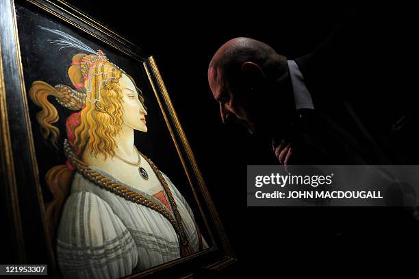 Visitors looks at Italian painter Sandro Boticelli's "Portrait of a Lady - Simonetta Vespucci" during a press preview of the exhibition "Renaissance...