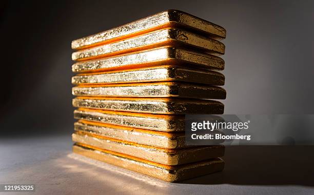 Gold bars are arranged for a photograph at Bullion Trading LLC in New York, U.S., on Tuesday, Aug. 23, 2011. Gold dropped the most in a year as some...