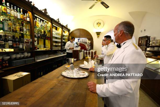 Waiters work at the 18th Century Cafe Florian on June 12, 2020 in Venice, which reopens after being closed for three months during the country's...