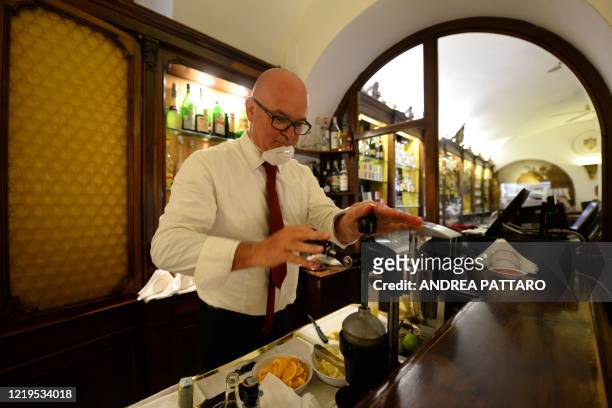 Bartender works at the 18th Century Cafe Florian on June 12, 2020 in Venice, which reopens after being closed for three months during the country's...