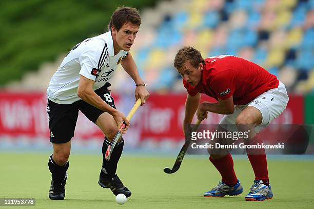 Oliver Korn of Germany is chased by Iaroslav Loginov of Russia during the Men´s EuroHockey Championships 2011 Pool A match between Germany and Russia...