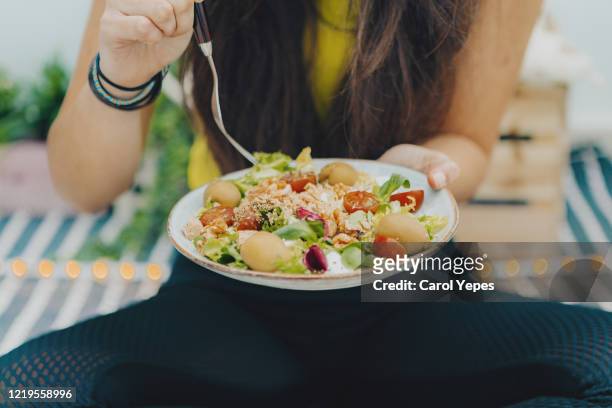 fitness girl eating fresh bowl salad at home - dietary fiber stock pictures, royalty-free photos & images