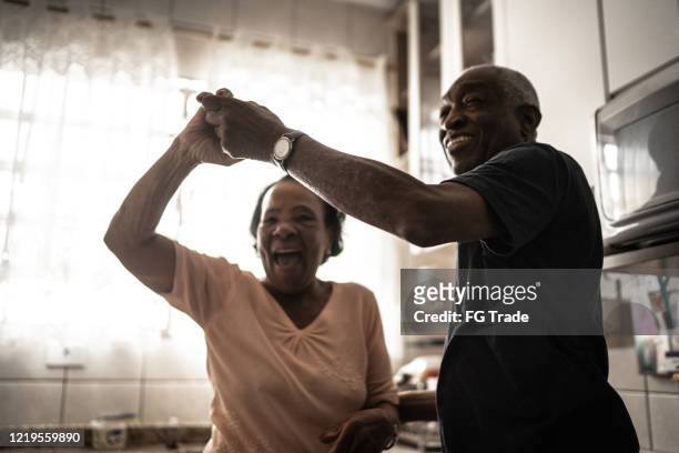 Senior couple dancing at kitchen