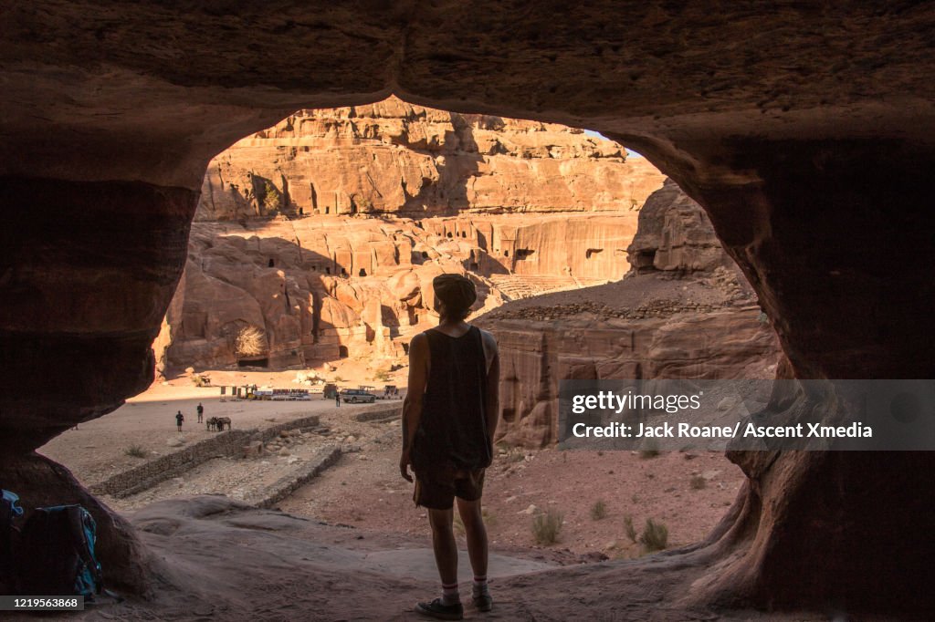 Young man explores the ancient ruins of Petra