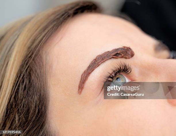 close-up photo of hair dye on woman's eyebrow - stock photo - color dye stock pictures, royalty-free photos & images