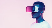 Web banner of young african man wearing virtual reality headset. VR concept.