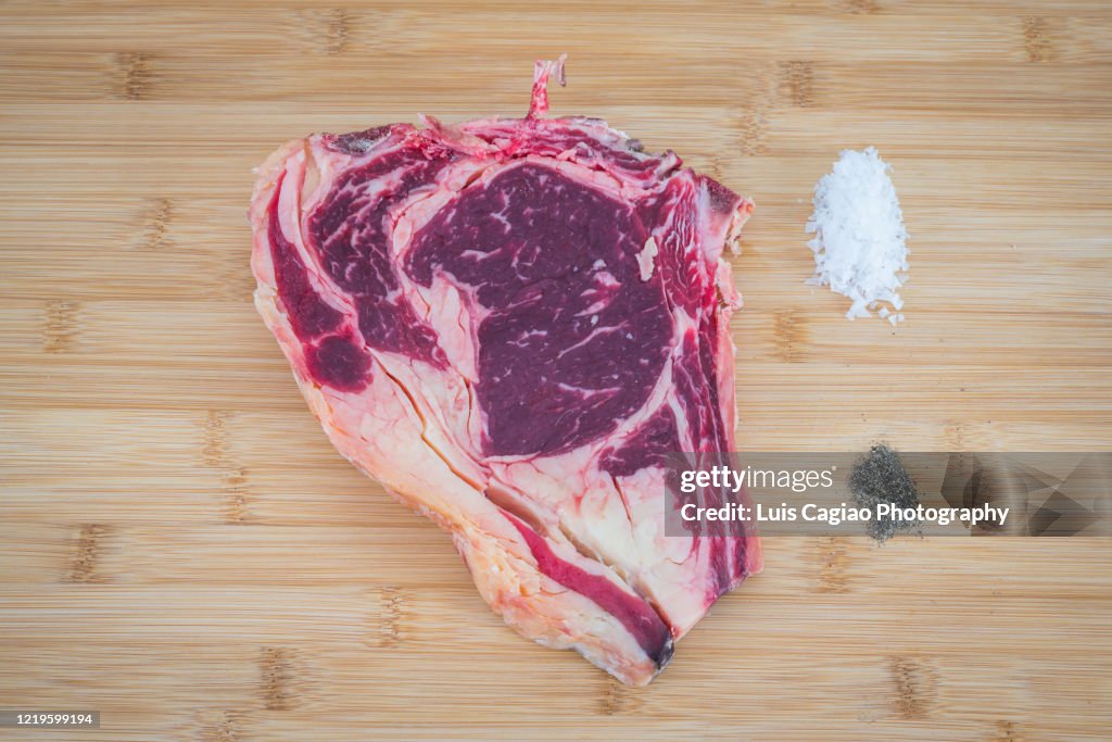 Dry aged T-bone steak with salt and pepper