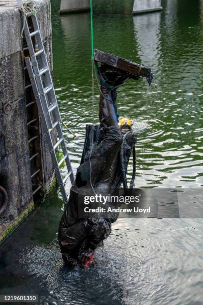 The statue of slave trader Edward Colston is retrieved from Bristol Harbour by a salvage team on June 11, 2020 in Bristol, England. The statue was...