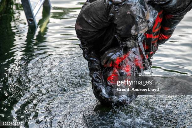 The statue of slave trader Edward Colston is retrieved from Bristol Harbour by a salvage team on June 11, 2020 in Bristol, England. The statue was...