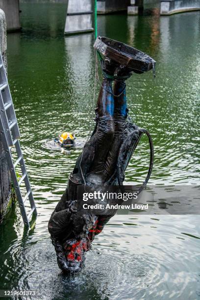 The statue of slave trader Edward Colston is retrieved from Bristol Harbour by a salvage team on June 11, 2020 in Bristol, England. The statue was...