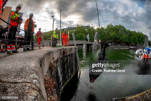 The statue of slave trader Edward Colston is retrieved from Bristol Harbour by a salvage team on June 11, 2020 in Bristol, England. The statue was...