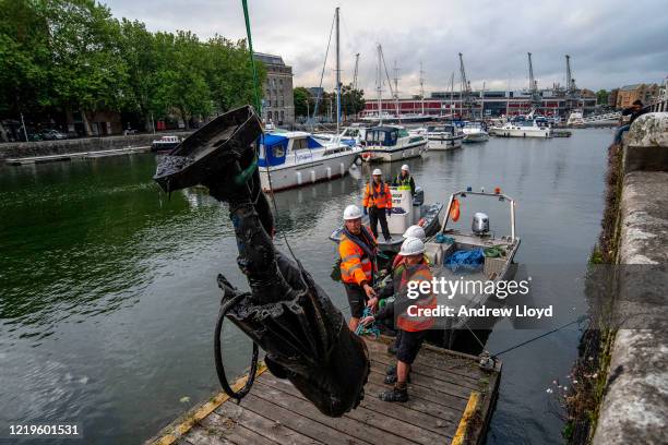 The statue of slave trader Edward Colston is retrieved from Bristol Harbour by a salvage team on June 11, 2020 in Bristol, England. The statue was...