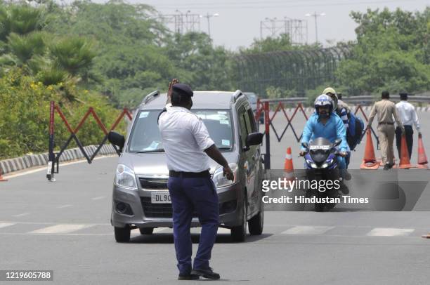 Uttar Pradesh traffic police personnel directing vehicles at Noida Gate along the Uttar Pradesh-Delhi border, on June 10, 2020 in Noida, India.