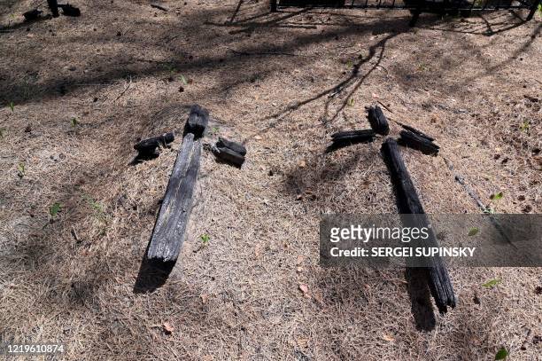 Picture taken on June 11, 2020 shows coalified crosses in a cemetery near Rozsokha village, in Chernobyl thirty-kilometer zone. - Huge forest fires...