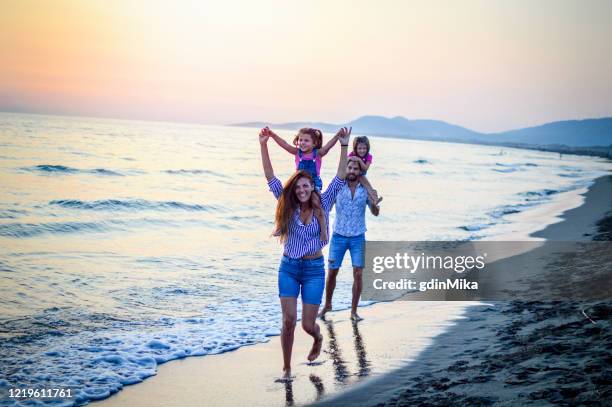 happy young family on the beach - adriatic sea stock pictures, royalty-free photos & images