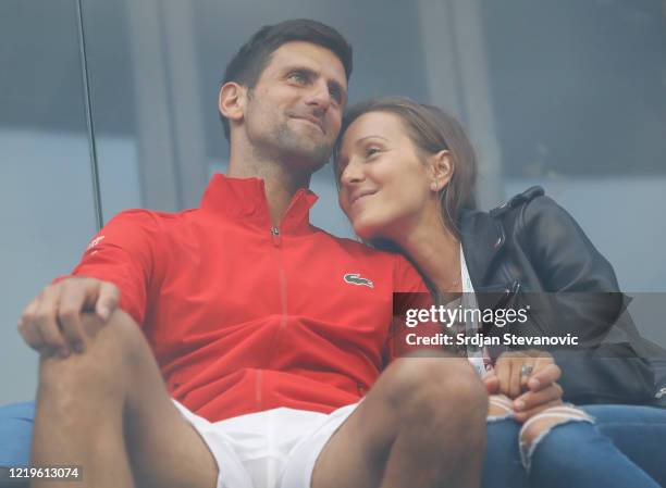 Novak Djokovic of Serbia relaxes with his wife Jelena Djokovic after the exhibition doubles match of the Adria Tour charity exhibition hosted by...