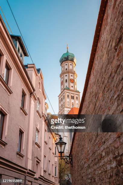 view through small alley up to church tower, augsburg, bavaria, germany - augsburg stock pictures, royalty-free photos & images
