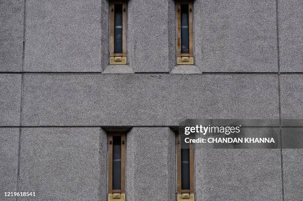 Prisoners look out of their jail window as protestors gather outside the federal detention center in Downtown Miami on June 12, 2020 in Miami, during...