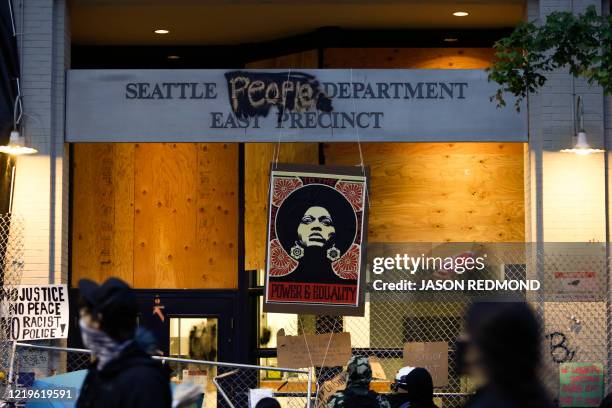 An image of activist Angela Davis is displayed above the entrance to the Seattle Police Department's East Precinct, vacated June 8, and now...